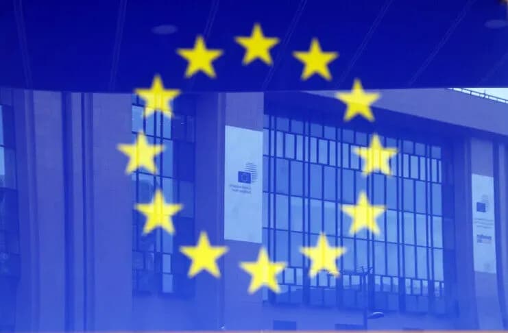 The flag of the European Union displayed in front of a European Commission building.
