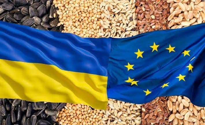 The Ukrainian and European Union flags superimposed over assorted agricultural grains.
