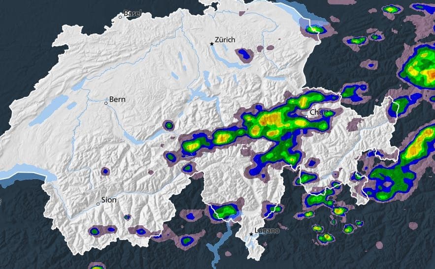 Weather radar map showing active thunderstorm cells moving across Switzerland towards the east, with areas of intense precipitation highlighted.