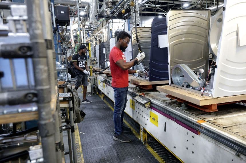 Workers on an appliance production line, symbolizing the manufacturing sector and producer costs.