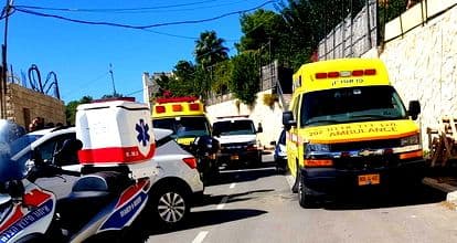 Yellow ambulances on a sunny street, representing emergency response to heat-related health risks.